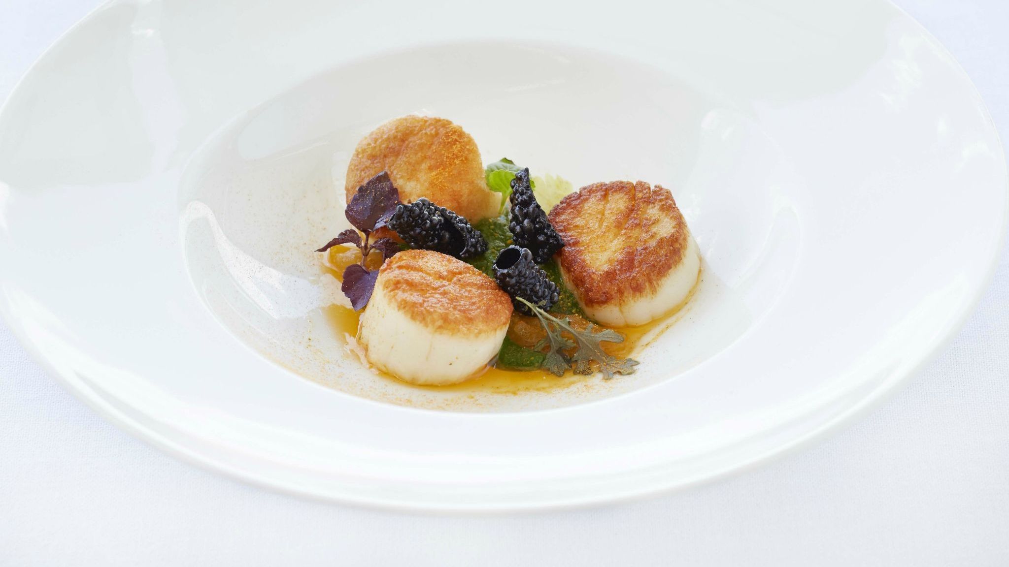 Grilled scallops with tandoori pea purée with coconut milk and lemongrass GB Roof Garden Restaurant