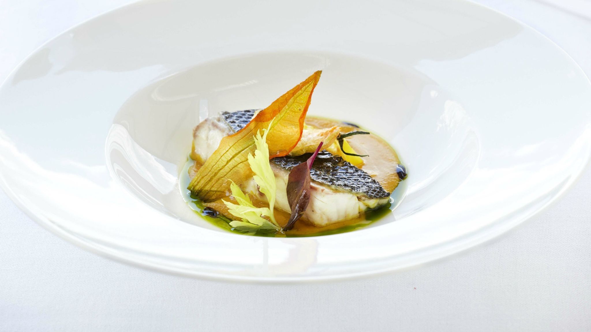 Sea-bass-confit-in-olive-oil-summer-vegetables-with-spearmint-and-yellow-tomato-syrup-with-star-anise-GB-Roof-Garden-Restaurant